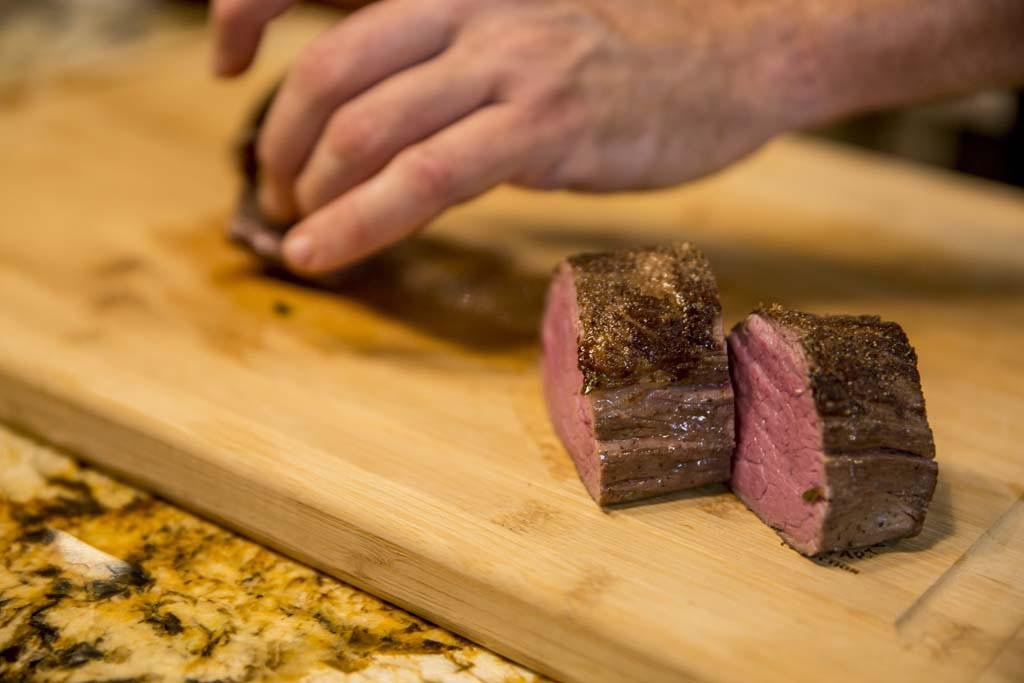 Maui Private Chef Kevin Bell slicing sous vide beef tenderloin.
